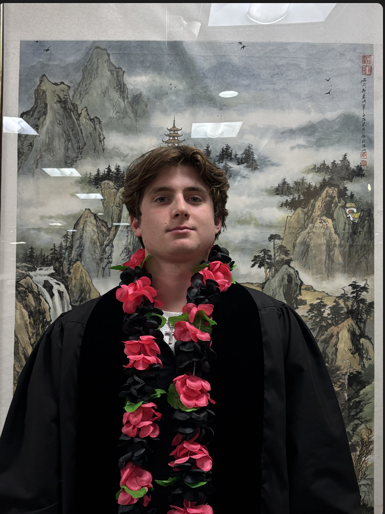 Professor Todd stands in black before a painting.